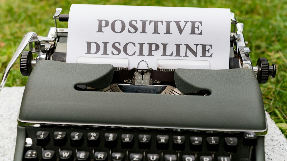 a close up of a typewriter with a paper that says positive, disc